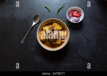 Indian style chicken curry served in a bowl on a dark background. Stock Photo