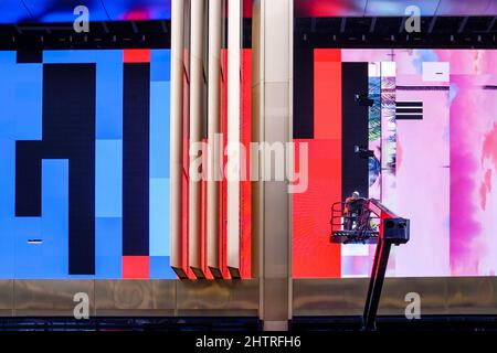 Technicians work on large video screens during construction of the Outernet complex, Charing Cross Road, central London, UK. Stock Photo