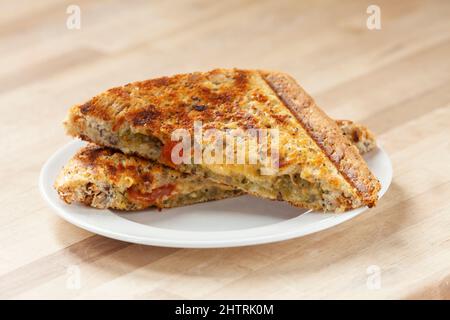 A cheese and tomato toasted sandwich cut in half Stock Photo