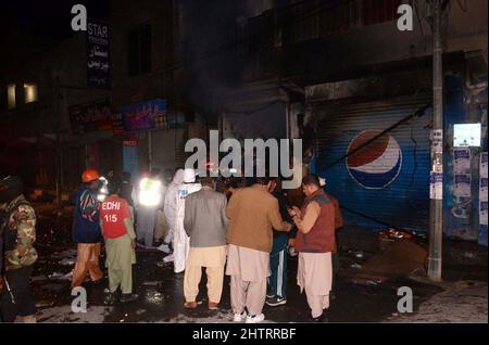 View of venue while security officials are cordon off the site for inspection and rescue operation is underway after a blast located on Fatima Jinnah road in Quetta on Wednesday, March 02, 2022. At least 25 people were injured and two people were killed after a blast struck Quetta's Fatima Jinnah Road. The blast took place near a police mobile and soon after the explosion, nearby shops caught fire. The Deputy Inspector-General (DIG) Quetta confirmed that a person has been illed in the blast while more than 10 have been injured. Stock Photo