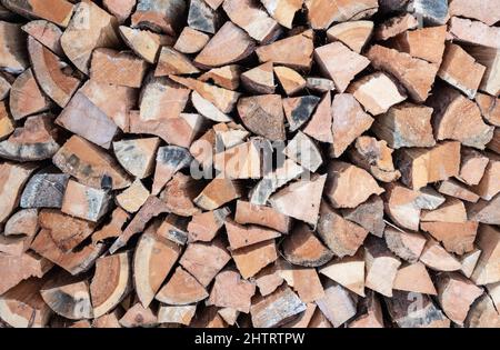 Stack of firewood. Chopped wood logs background. Stock Photo