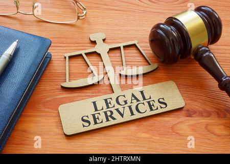 Gavel and scale model with inscription legal services. Stock Photo