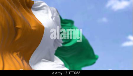 Detail of the national flag of Ivory Coast waving in the wind on a clear day. Ivory Coast is a country on the southern coast of West Africa. Selective Stock Photo