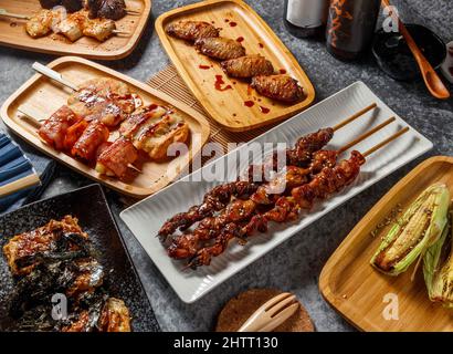 Chicken gizzard, chicken skin, chicken fart, midsection chicken wings, Shiitake mushroom, apricot abalone, Fragrant Bean Buns, baby corn, in wooden di Stock Photo