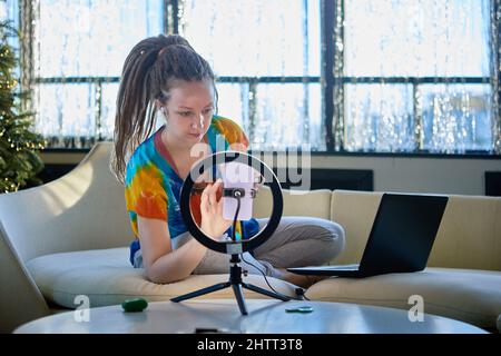 Live streaming by beauty blogger who uses ring light and cellphone. Stock Photo