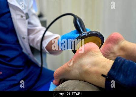 shock wave therapy procedure in the doctor's office Stock Photo