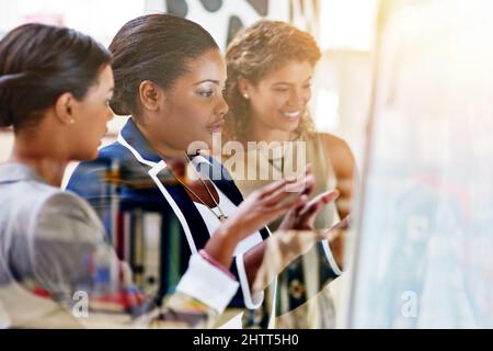 Great ideas in the making. Shot of a group of female coworkers brainstorming together in an office. Stock Photo