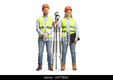 Male and female geodetic surveyors posing with a measuring station isolated on white background Stock Photo