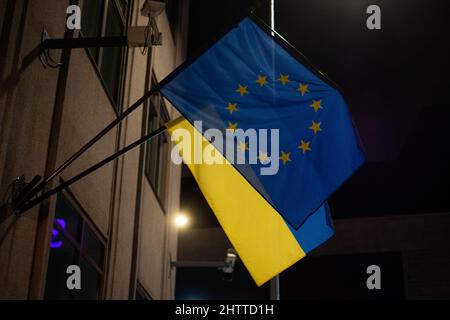 Flags of Ukraine and European Union waving together symbolising accession negotiations. Concept of Ukraine joining EU. Stock Photo