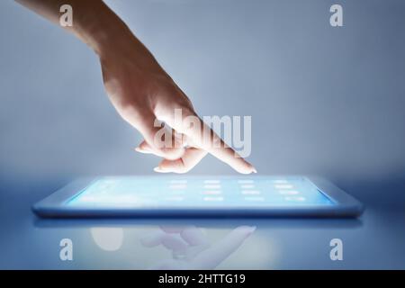 Intuitive technology. Cropped closeup of a womans hand above a digital tablet. Stock Photo