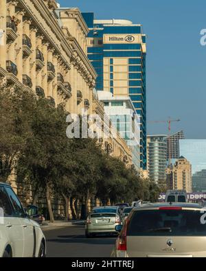 Baku, Azerbaijan - January 09 2022-Highway in the city with cars and buildings and hotel in the background. Stock Photo