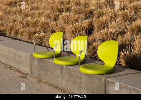 Close-up of three chairs on the walkway in the street Stock Photo