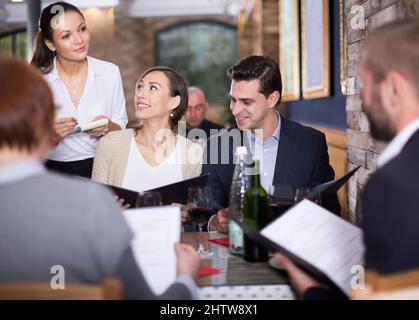 waitress female taking order from guests Stock Photo