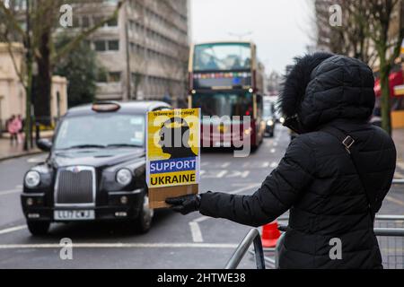 London, UK - March 2nd 2022: A anti-war protestor outside the Russian Embassy in London, UK, protesting against the Russian invasion of Ukraine. Stock Photo