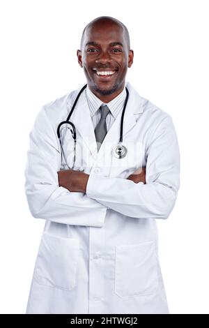 Ill have to fit as a fiddle. Cropped portrait of a male doctor standing with his arms folded against a white background. Stock Photo