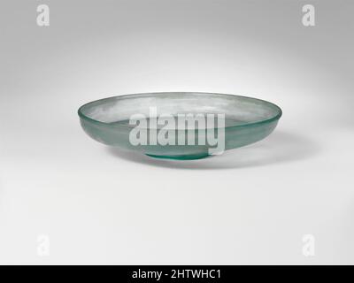 Art inspired by Glass dish, Late Imperial, 4th century A.D., Roman, Glass; blown, H. 1 1/4 in. (3.2 cm), Glass, Translucent blue green. Vertical, slightly thickened, rounded rim; short, convex side to body, turned in horizontally, and then sloping inwards to thick, flat bottom with, Classic works modernized by Artotop with a splash of modernity. Shapes, color and value, eye-catching visual impact on art. Emotions through freedom of artworks in a contemporary way. A timeless message pursuing a wildly creative new direction. Artists turning to the digital medium and creating the Artotop NFT Stock Photo