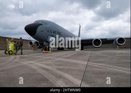 U.S. Airmen from the 190th Air Refueling Wing conduct preflight checks on a KC-135 Stratotanker assigned to the 117th Air Refueling Squadron, Forbes Field Air National Guard Base, Topeka, Kansas, currently stationed at Kadena Air Base, Japan, Feb. 24, 2022. The KC-135 Stratotanker can hold up to 200,000 pounds of fuel, which is pumped through the tanker’s flying boom and utilized mid-flight to refuel a variety of aircraft thus extending its global reach to maintain a free and open Indo-Pacific. (U.S. Air Force photo by Airman 1st Class Yosselin Perla) Stock Photo