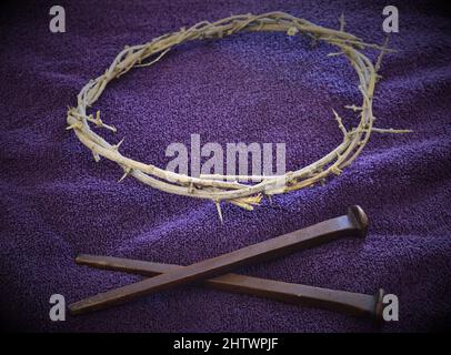 Nails and Crown of Thorns on Purple cloth (3B) Stock Photo