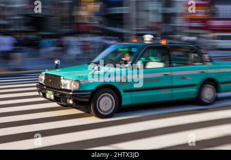 Blur of passing taxi in Shibuya, Tokyo, Japan Stock Photo