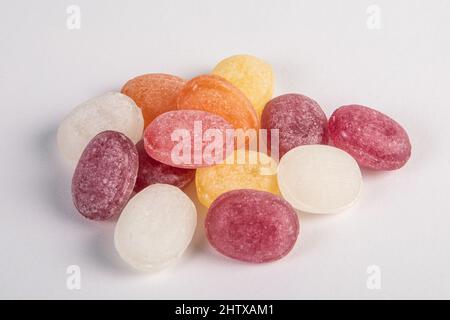 Colored candies stacked on a white background. Lollipops and sweets. Stock Photo