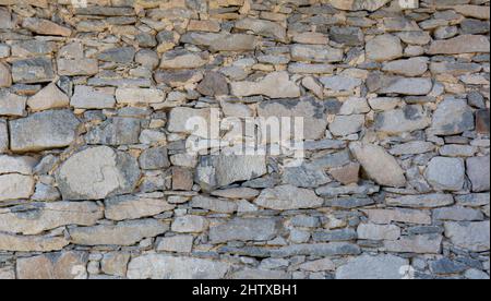 Old antique stone wall texture. Rocky Structure Backdrop. Background. Stock Photo