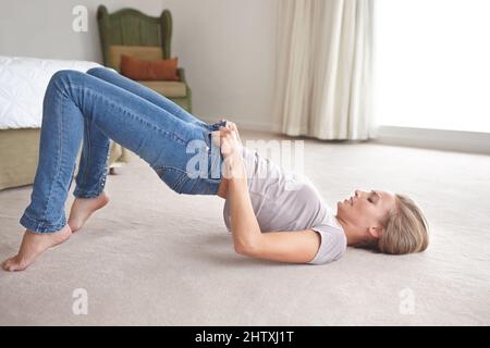 woman struggling to pull on her denim jean Stock Photo - Alamy