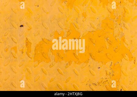 Orange grunge metal background with scratches and rust on steel painted embossing surface of building wall. Stock Photo