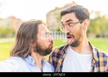funny gay couple looking at each other and making grimaces Stock Photo