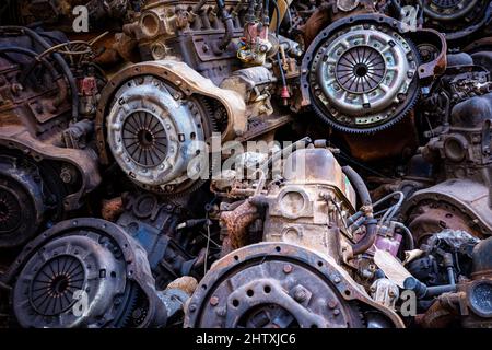 Pile of rusty and dirty obsoleted old vehicle metal engine and spare parts in outdoor. Stock Photo