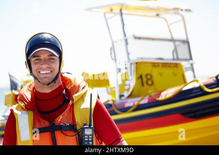 I love sea rescue. Cropped portrait of a handsome young male lifeguard preparing to go out to sea on a rescue mission. Stock Photo