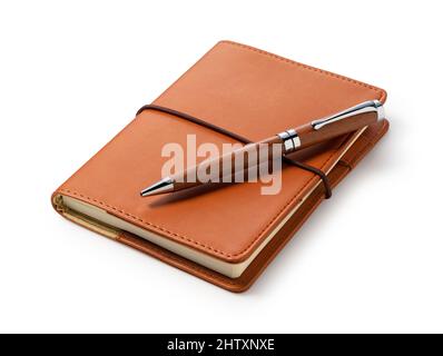 Leather notebook and pen placed against a white background. Business image. Stock Photo