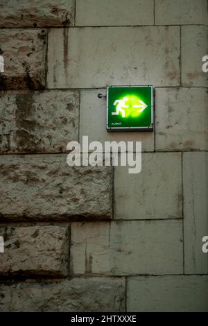Rescue sign, emergency exit, sign on a wall Stock Photo
