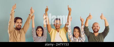 People with approving expression looking at camera showing success and like gesture on background. Stock Photo