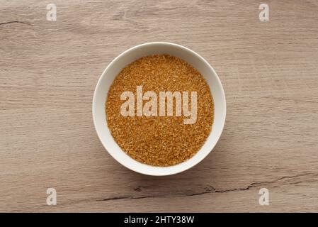 Sugar cane in a bowl on wooden background. Top view. Stock Photo