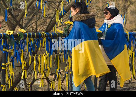 Girls during a peaceful demonstration against war, Putin and Russia in support of Ukraine, with people, ribbons and flags. Stop War Stock Photo