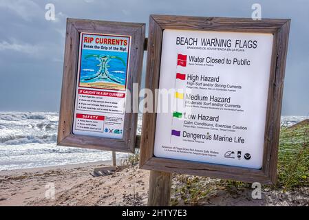Beach warning signs at Vilano Beach Oceanfront Park near St. Augustine, Florida, during a Nor'easter storm that brought high wind and rough seas. Stock Photo