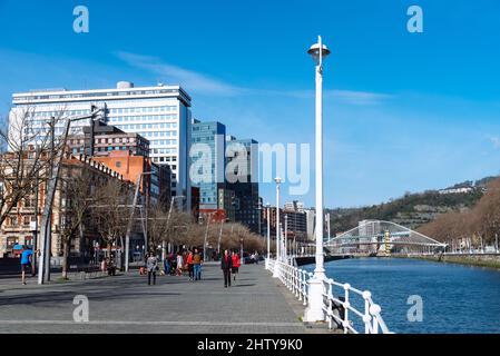 Bilbao, Spain - February 13, 2022: View of the promenade along the estuary of Bilbao. Stock Photo