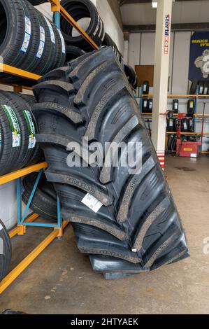 Large tractor tyre ready for sale at a tyre depot in Norfolk, UK Stock Photo