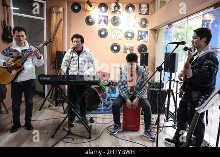 (220303) -- GUIYANG, March 3, 2022 (Xinhua) -- Guitarist Yang Zhi, lead singer Chen Kexing, drummer Chen Changhai and bassist Peng Wanhai (L to R) have a rehearsal in Guiyang, southwest China's Guizhou Province, March 1, 2022. A band named 'Fish Mint' consists of three massage therapists and a delivery man who were all born in the 1990s. Yet the delivery man is the only one who could see while the rest are with visual impairment. The members do their regular work during the day and gather around to play music in the band in the evening. The band is named after fish mint, as the members think Stock Photo