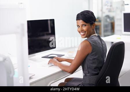 Im always on the job. Shot of an attractive young woman businesswoman in her office. Stock Photo