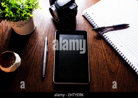 Top view of a tablet pens and a notebook on the desk Stock Photo