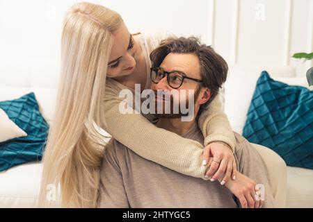adorable millennial couple cuddling and looking each other in the eye, trustful and happy relationship concept. High quality photo Stock Photo