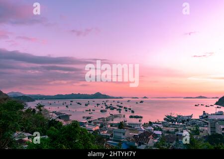 Sunset on Labuan Bajo harbor with purplish sky Stock Photo