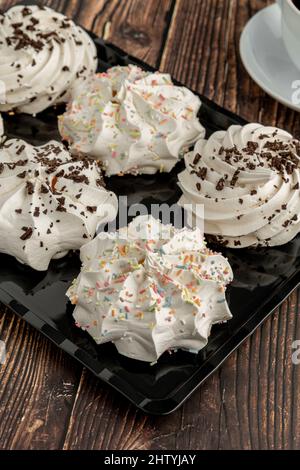 meringue cookies or beze cookies with candy and chocolate Stock Photo