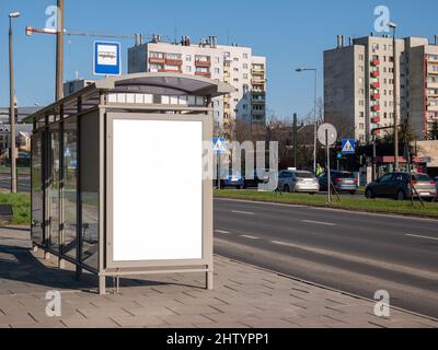 Empty blank white cut out bus stop advertisement poster, vertical ad banner sign board, city advert on the street, urban public space advertising plac Stock Photo