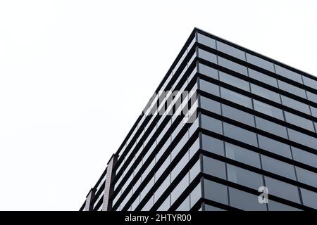 Generic corporate architecture modern building, contemporary office windows, low angle shot, simple minimal bright background, clear white sky copy sp Stock Photo