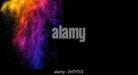 Color powder splash explosion on black background. Abstract multicolor tint rainbow design. Vibrant cloud dust creative art. Stock Photo