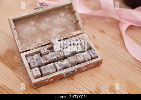latin letter stamps in a box. lifestyle Stock Photo