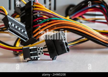 Detail of power supply unit with colored cables and peripheral connectors Stock Photo