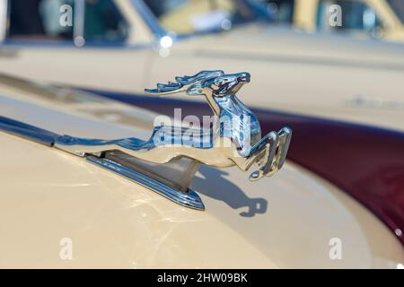 KRONSTADT, RUSSIA - SEPTEMBER 14, 2019: Chrome figure of a running deer on the hood of a Soviet retro car Volga GAZ-21 Stock Photo